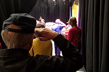 Jim Sharp and others stand for national anthem backstage at auditorium dedication. Image courtesy of Mel Borst