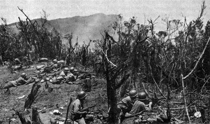 128th Infantry Regiment, entrenched along the Villa Verde Trail, Philippines; photo courtesy of the U.S. Army Signal Corps.
