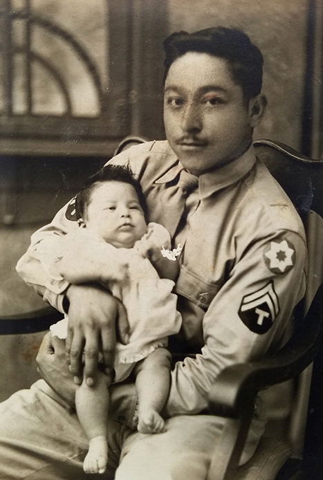 U.S. Army Technical Corporal Natividad Aguilar holding his infant daughter. Picture taken in Manhattan in 1943.